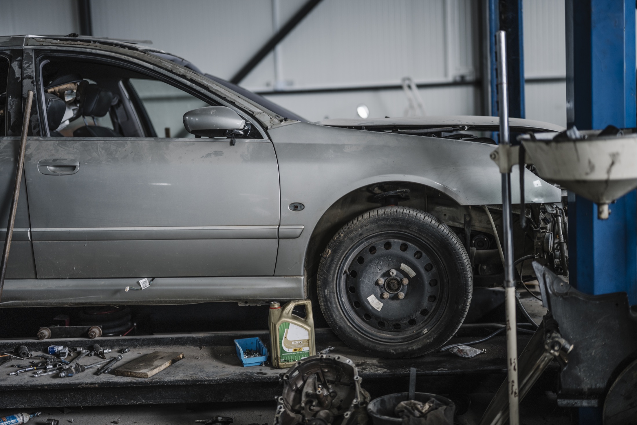 Vehicle raised on a workshop lift for inspection and repair